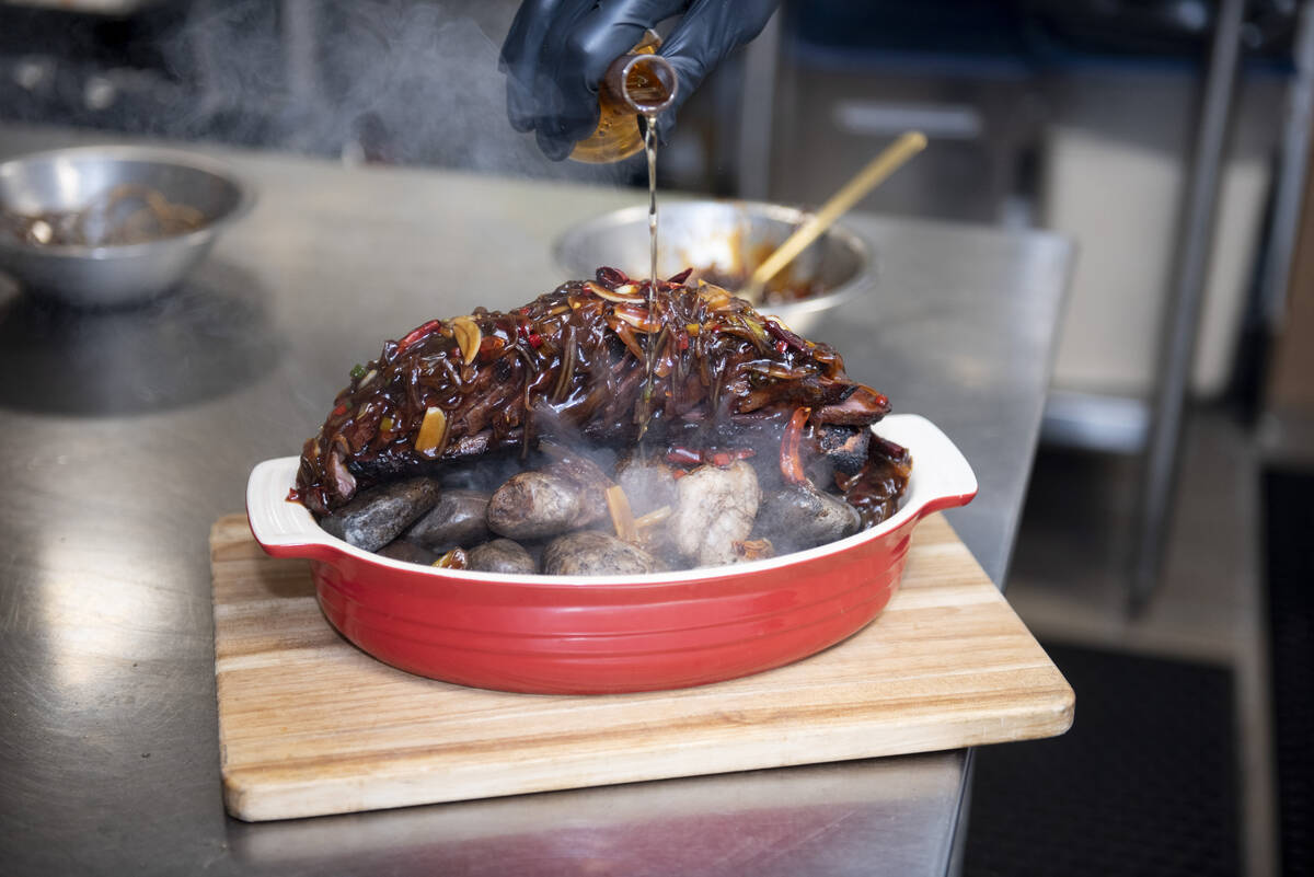 Chef Yip Cheung prepares the Chef's Special Short Rib Served on Ishiyaki Sizzling Stones at Red ...