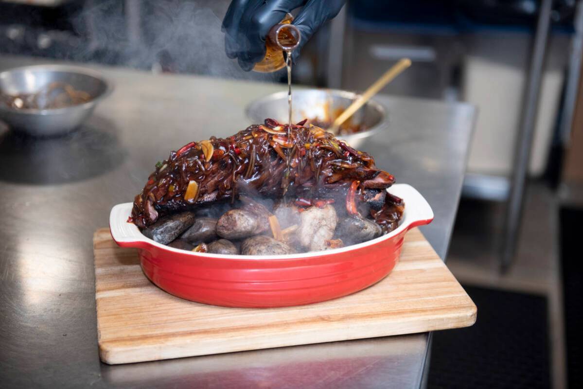 Chef Yip Cheung prepares the Chef's Special Short Rib Served on Ishiyaki Sizzling Stones at Red ...