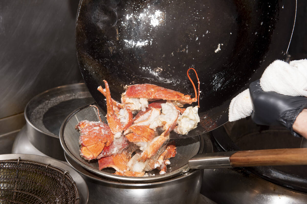 Chef Yip Cheung prepares the Stir-Fried Lobster with Lemongrass and Thai Sauce at Red Plate, a ...