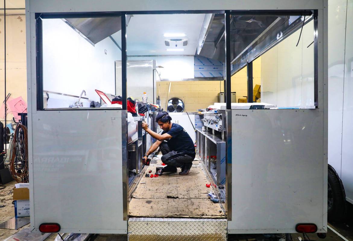 Manager Alex Sorianno works on a custom build truck at Ibarra’s, a food truck building a ...