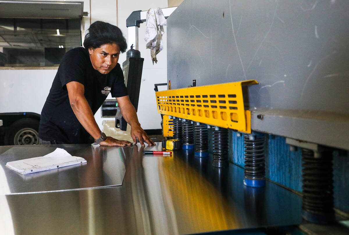 Manager Alex Sorianno works on parts for a truck at Ibarra’s, a food truck building and ...