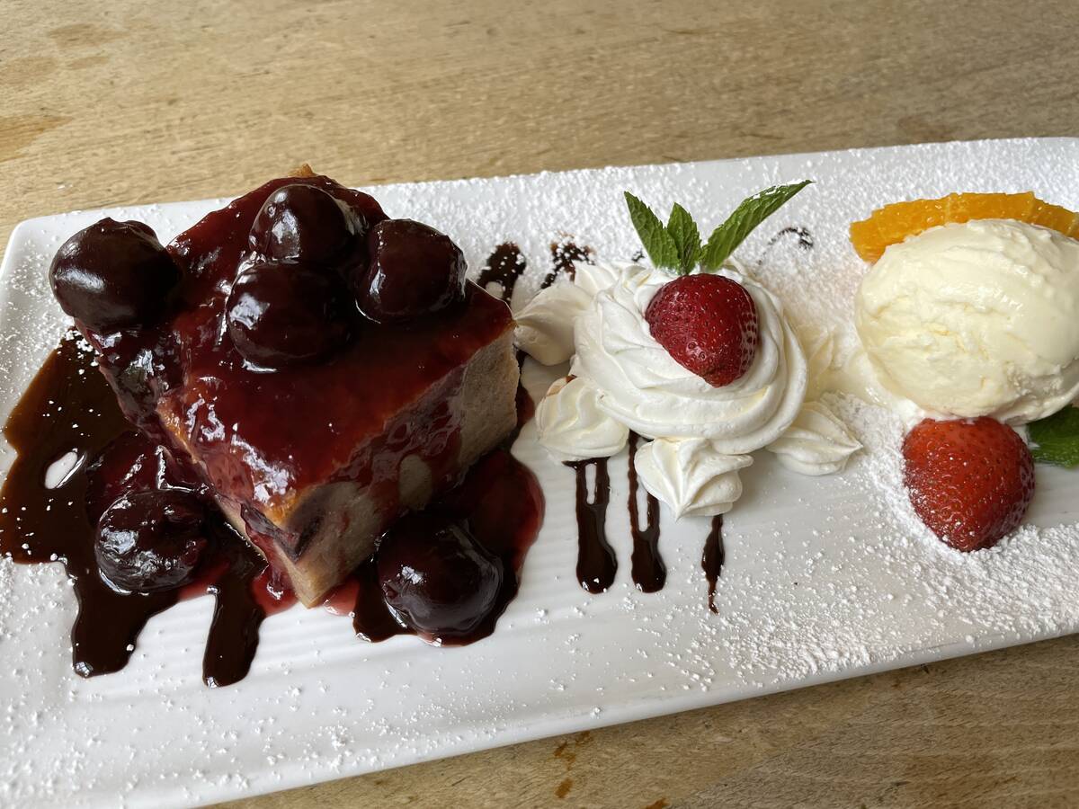 Housemade Black Forest bread pudding with black cherries and vanilla ice cream is one of two sw ...