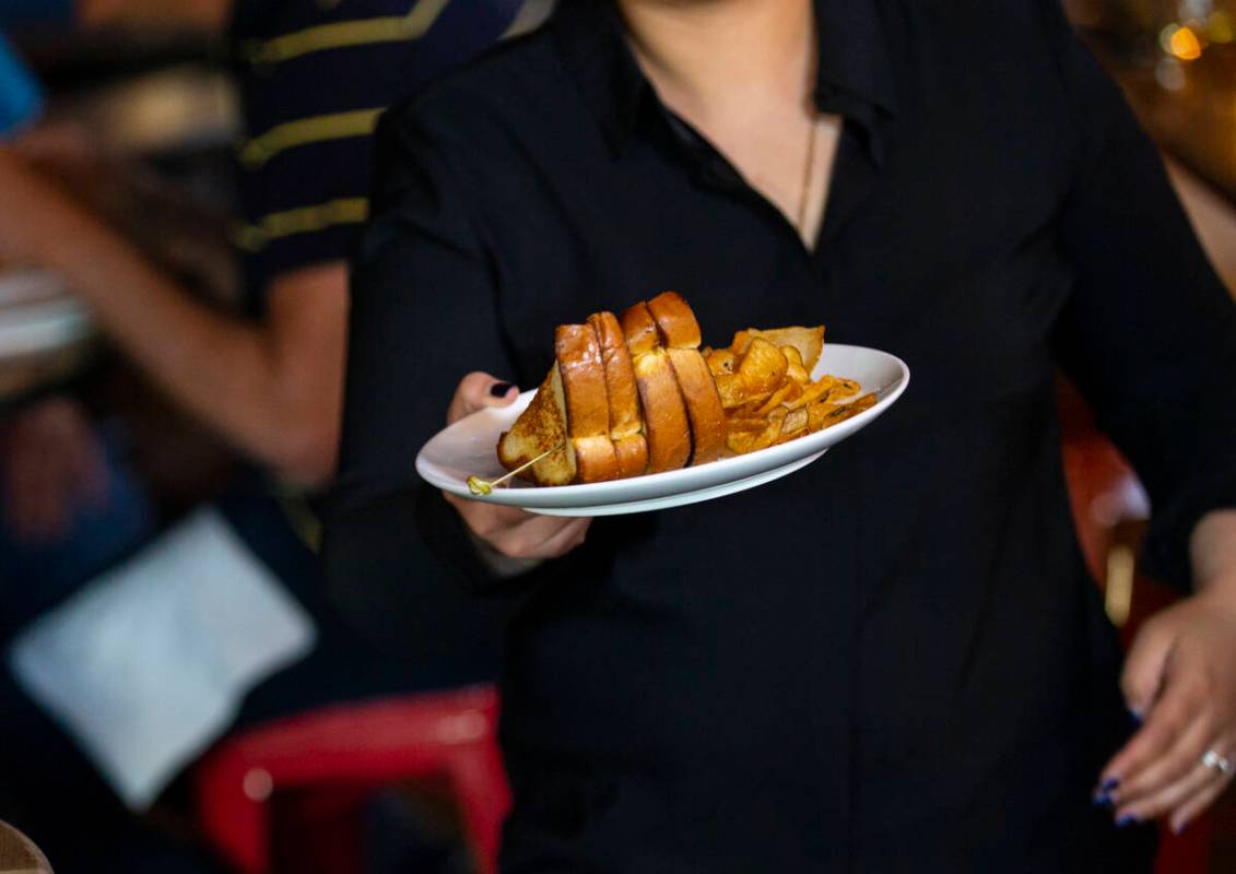 Waitress Blanca Prado carries Jersey Boys PBJ&B sandwiches during a presentation by Random ...