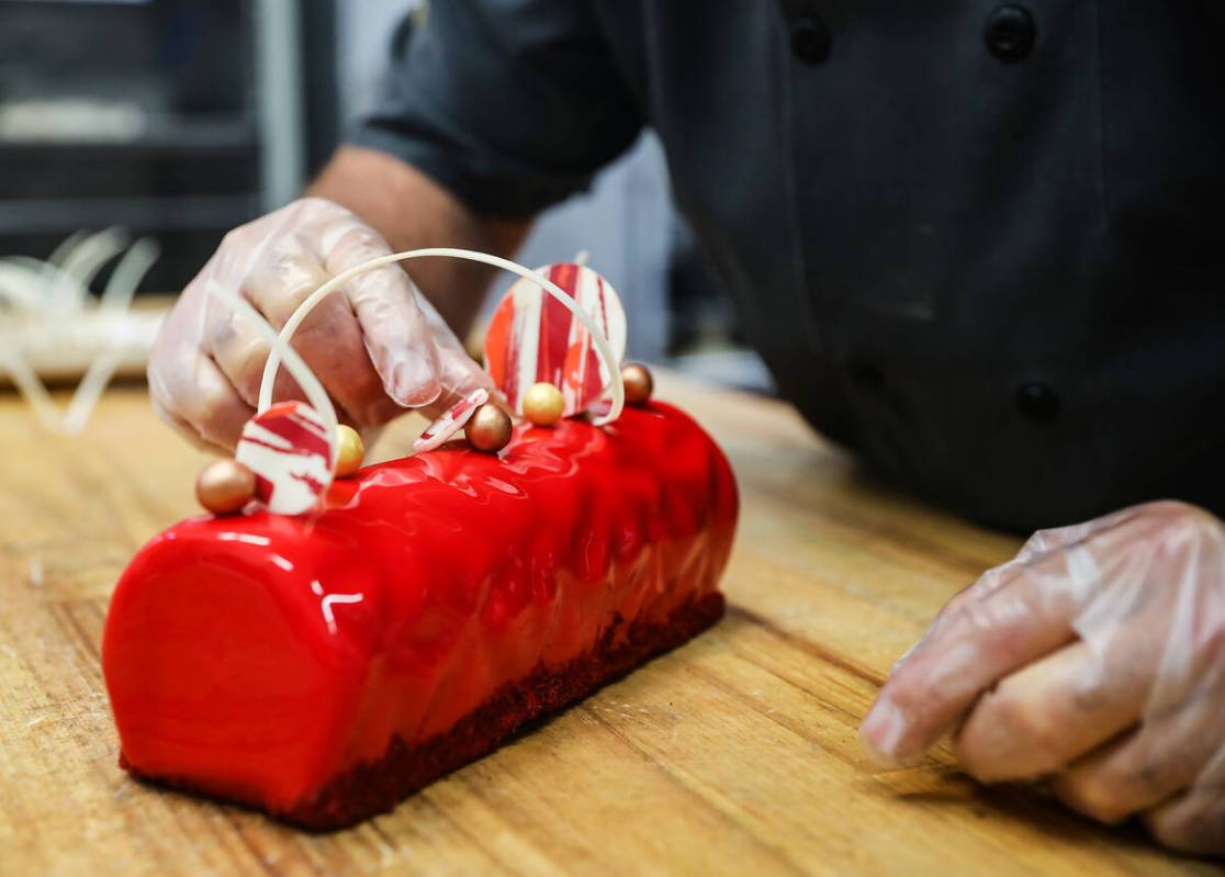 Executive Pastry Chef Doug Taylor adds finishing touches to a Father’s Day special panna cott ...