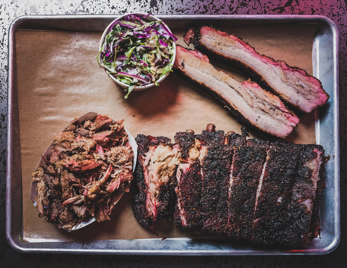 A platter of pork spareribs, pulled pork, and poppyseed slaw from Mabel's BBQ in the Palms in L ...