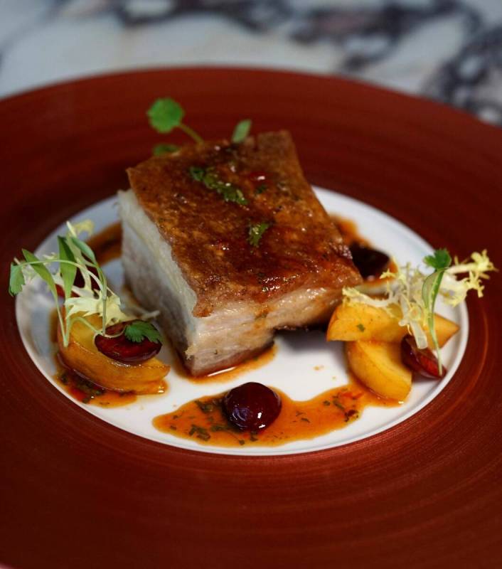 Carversteak at Resorts World Las Vegas is offering à la carte specials like crispy pork belly ...