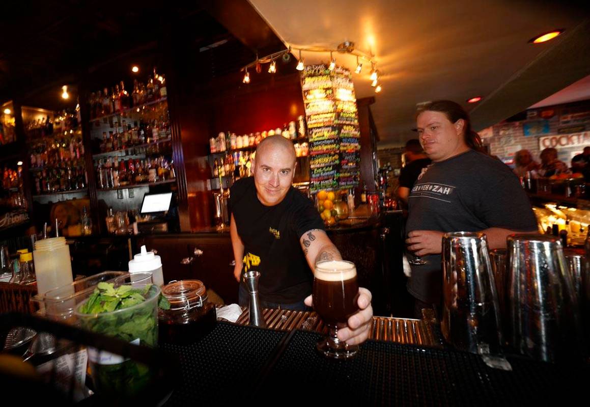 Kyle Weniger, former head brewer of Joseph James Brewing Co., left, shows a glass of Joseph Jam ...