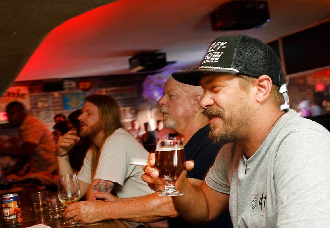 Adam Allen of Las Vegas holds a glass of Joseph James Suave Felon #003 at Atomic Liquors, Satu ...