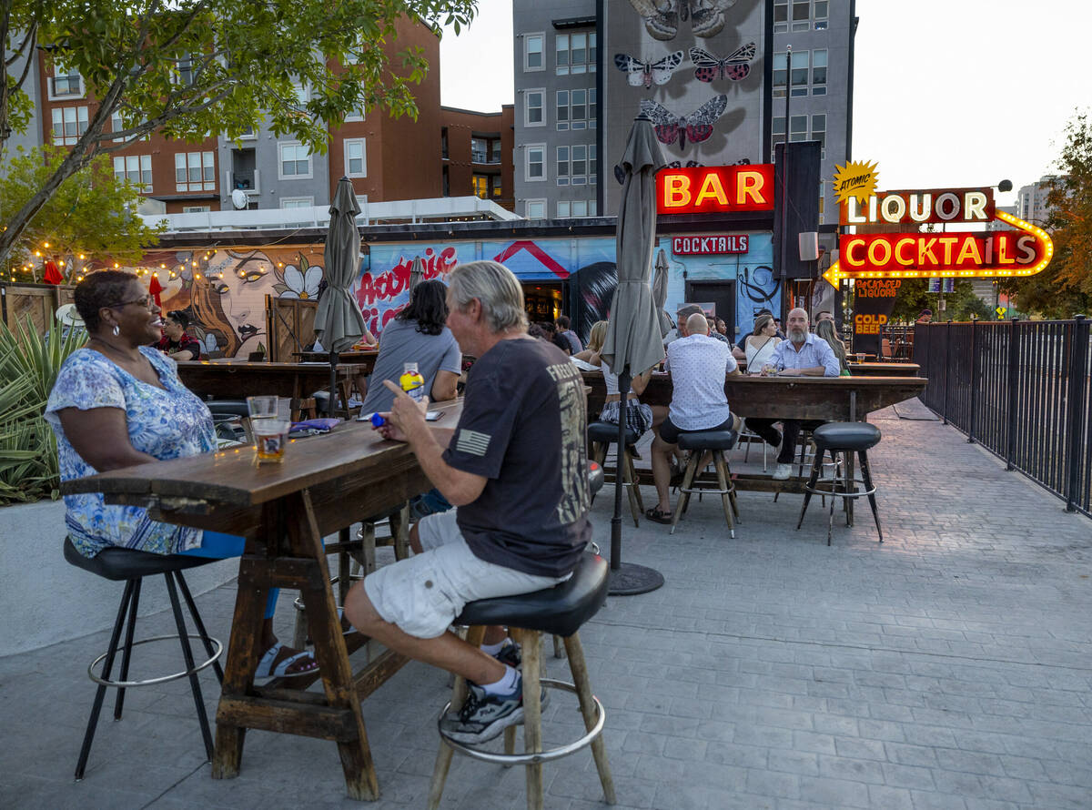 The outside patio begins to fill up with patrons for the start of the Atomic Liquors 70th anniv ...