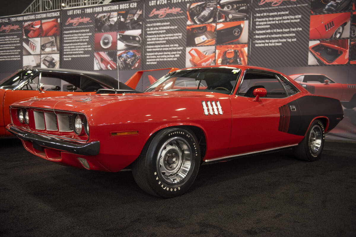 A 1971 Plymouth Hemi 'Cuda, one of only 59 4-speeds made, sits on the floor for the Barrett-Jac ...