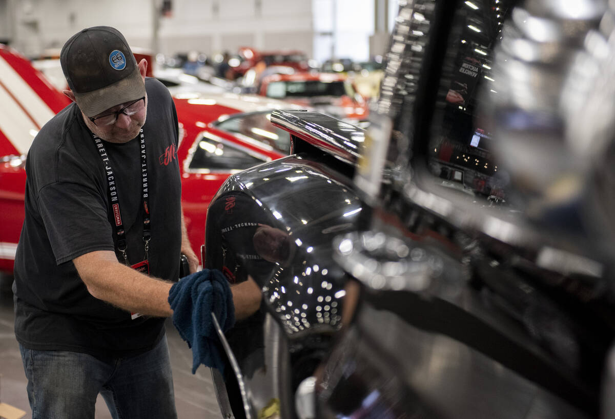 Don Williams, of Alberta, Canada, details a 1977 Chevrolet custom pickup before the the Barrett ...