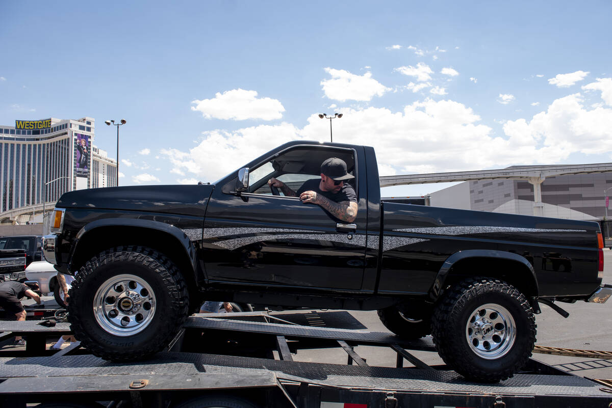 Dan Hogan of Phoenix unloads a 1997 Nissan pickup at the Barrett-Jackson car auction at the Las ...