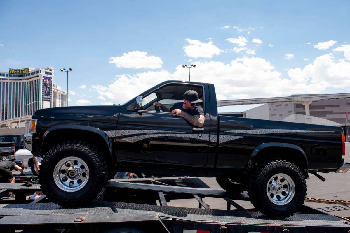 Dan Hogan of Phoenix unloads a 1997 Nissan pickup at the Barrett-Jackson car auction at the Las ...