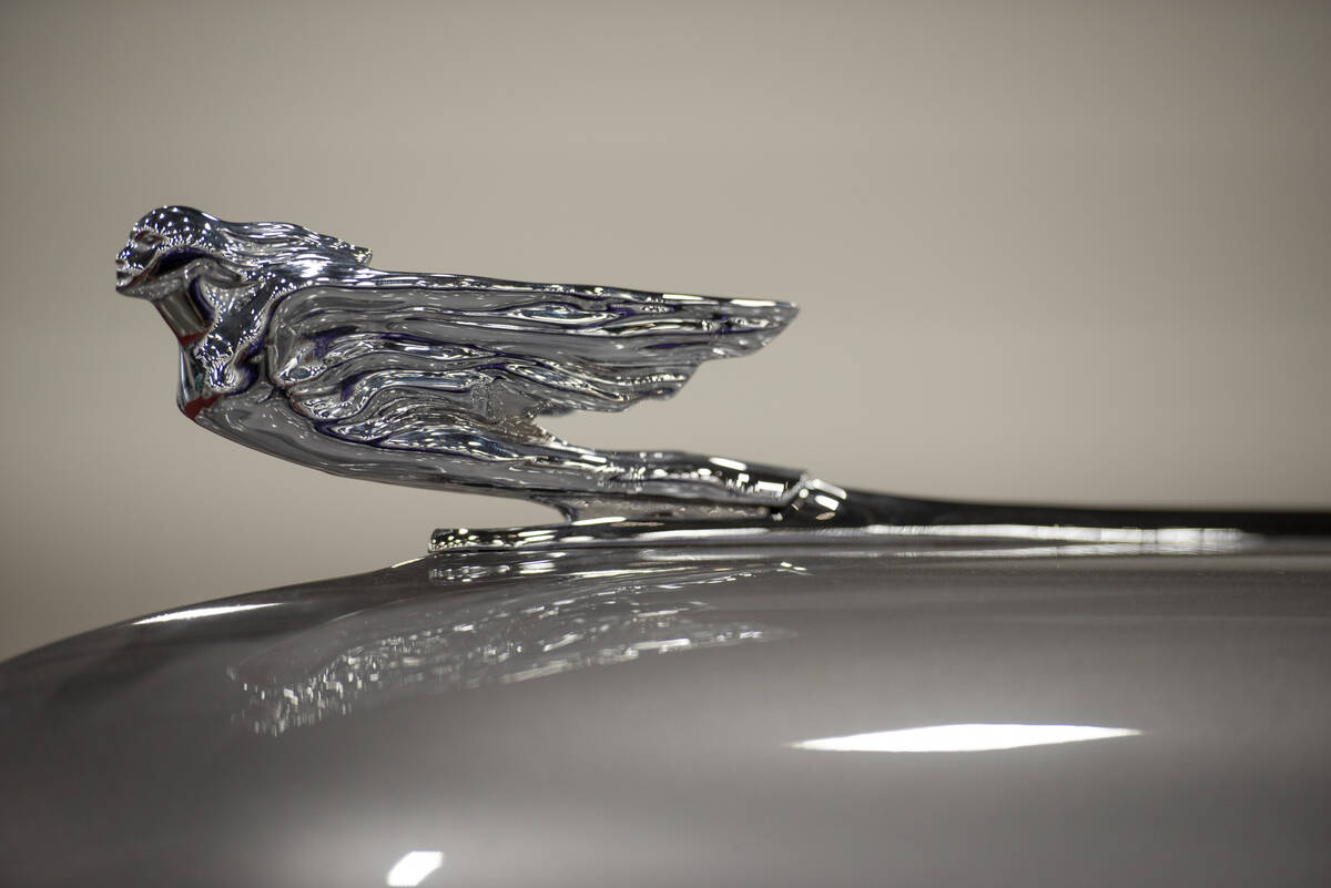 The hood ornament of a 1941 Cadillac Series 62 custom convertible at the Barrett-Jackson car au ...