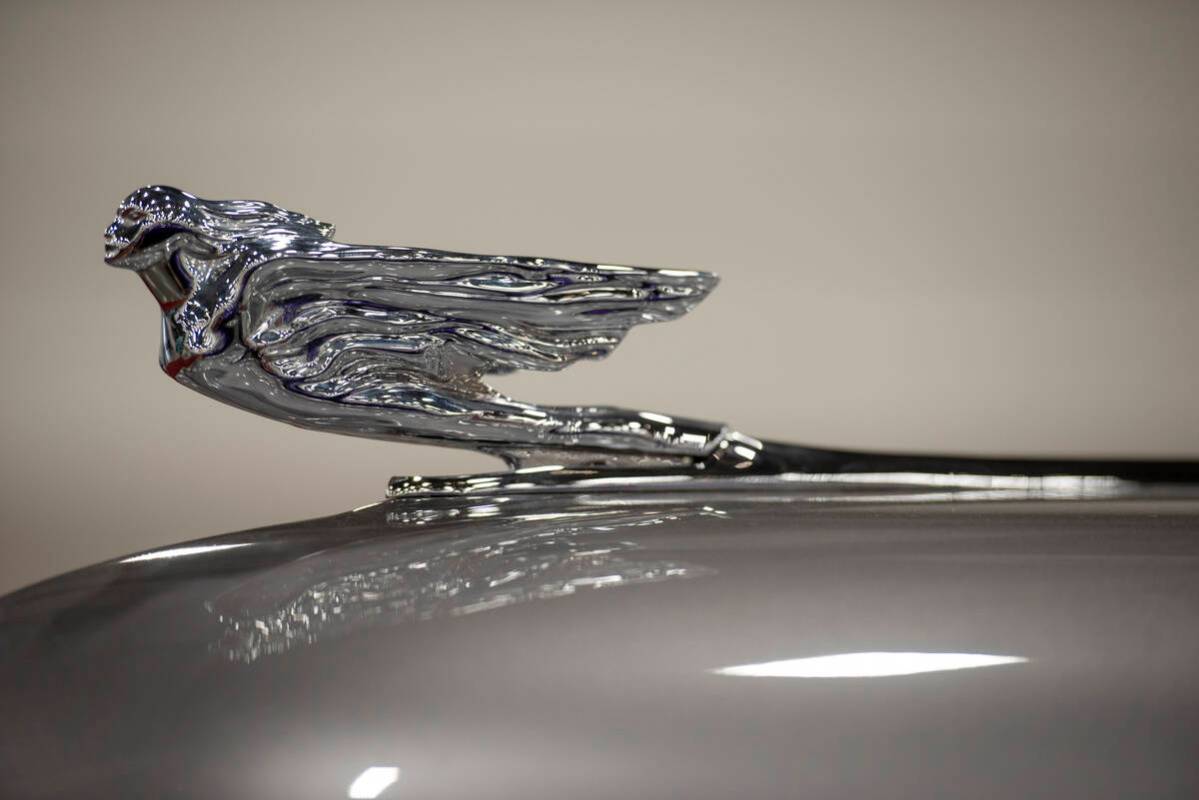 The hood ornament of a 1941 Cadillac Series 62 custom convertible at the Barrett-Jackson car au ...