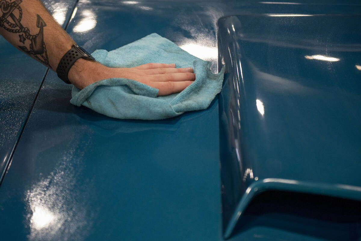 Frank Gregor, of Pennsylvania, polishes a 1969 Mercury Cougar convertible for the Barrett-Jacks ...