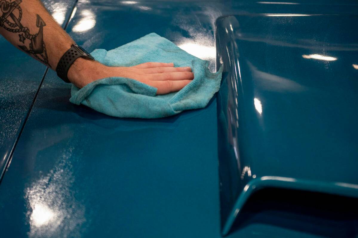 Frank Gregor, of Pennsylvania, polishes a 1969 Mercury Cougar convertible for the Barrett-Jacks ...