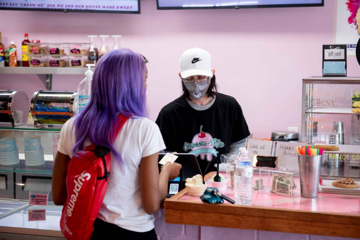 Chanel Aire, of Las Vegas, gets ice cream for her and her son from Axel Vega at Cream Me Ice Cr ...