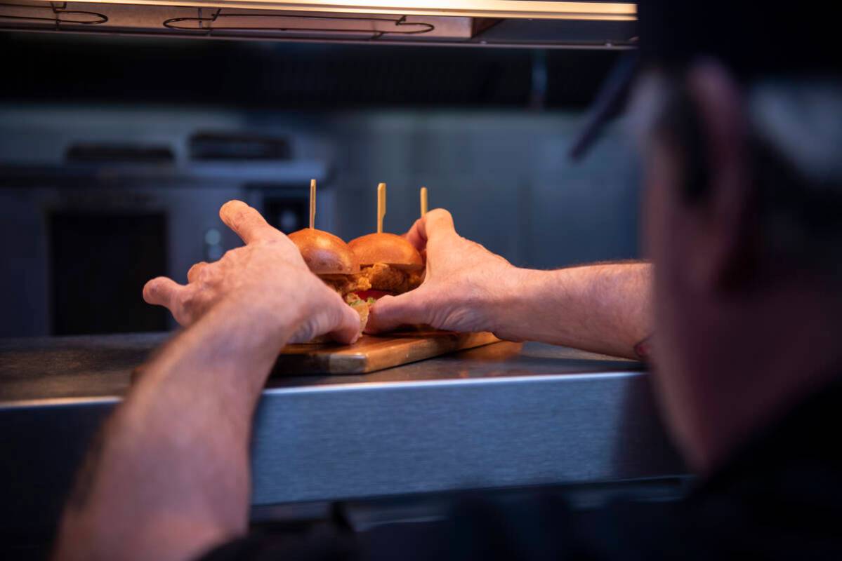 Chef Dermot Driscoll of Brooklyn Bowl prepares a tray of fried chicken sliders on Friday, July ...