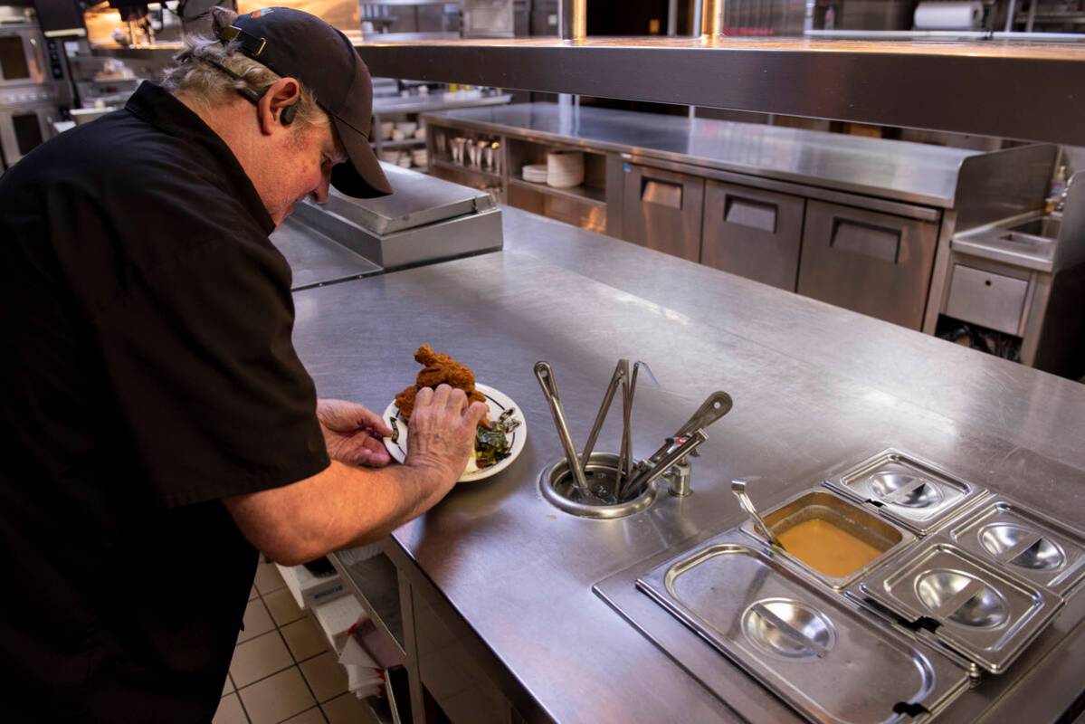 Chef Dermot Driscoll prepares a fried chicken dinner at Brooklyn Bowl on Friday, July 8, 2022, ...