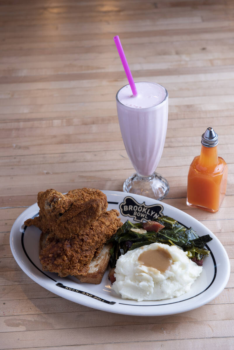 The fried chicken dinner with hot sauce and a strawberry milkshake at Brooklyn Bowl on Friday, ...