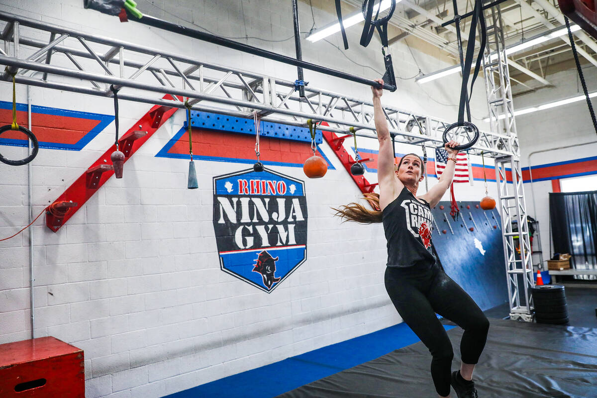 Owner Julie Johnston swings in an obstacle course at Rhino Ninja Gym in Las Vegas, Sunday, July ...