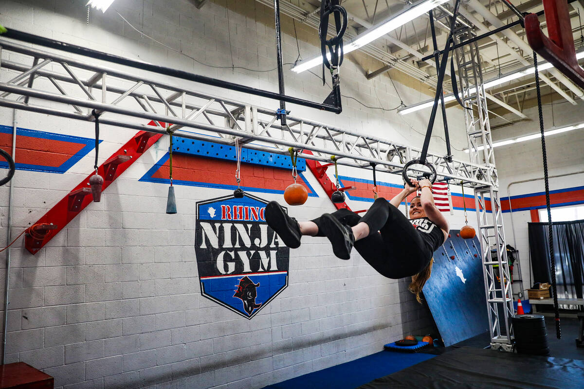 Owner Julie Johnston swings in an obstacle course at Rhino Ninja Gym in Las Vegas, Sunday, July ...