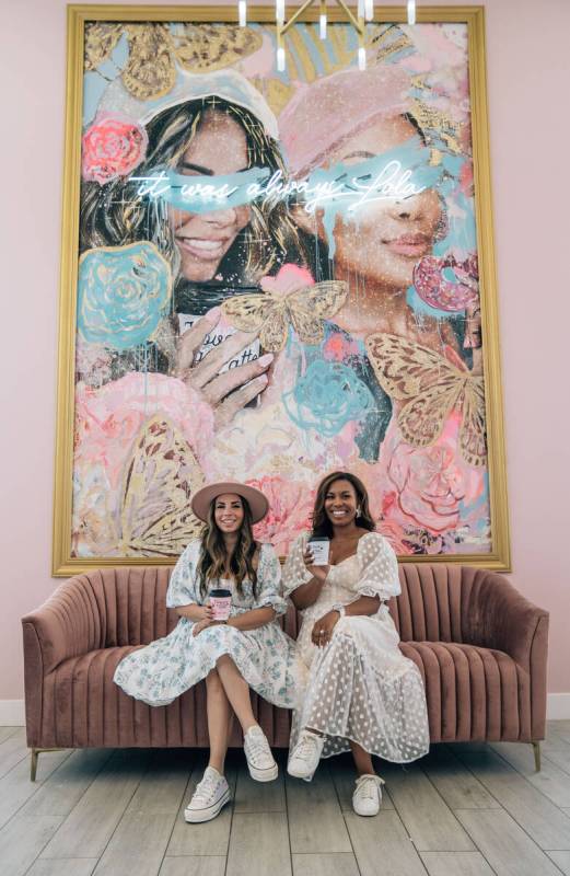 Alexandra Lourdes, left, and Lin Jerome, owner of the Café Lolas, take a moment beneath their ...