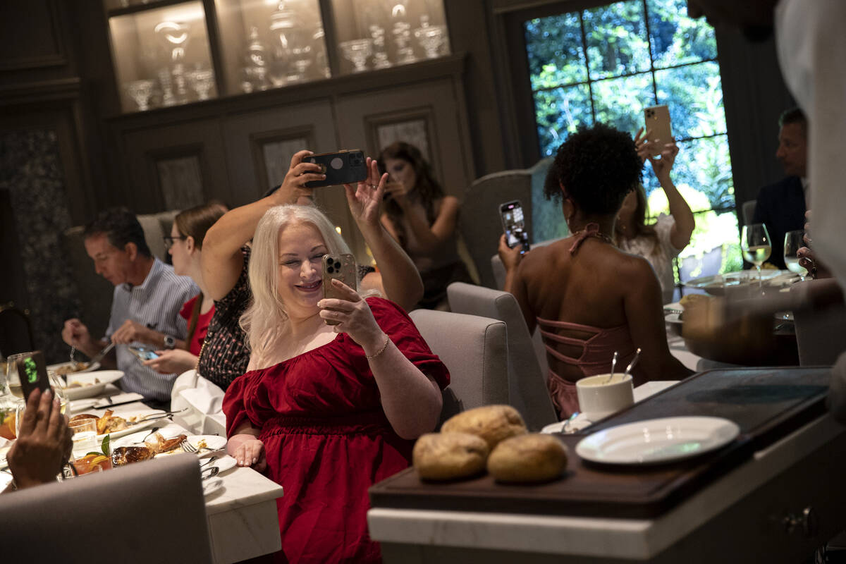 Guests watch as a chef prepares Martha’s smashed baked potato tableside during a media r ...