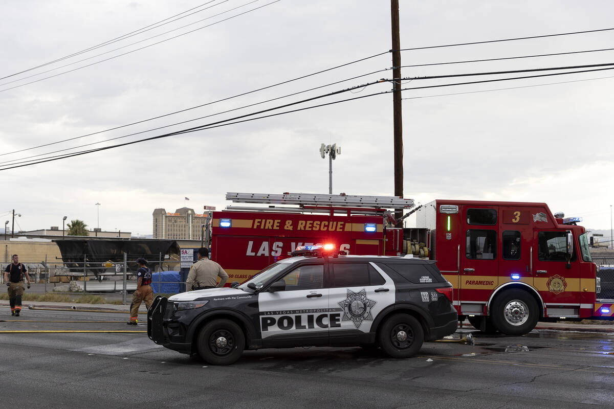 Metropolitan police respond while Las Vegas fire crews put out a fire on the 2300 block of Indu ...