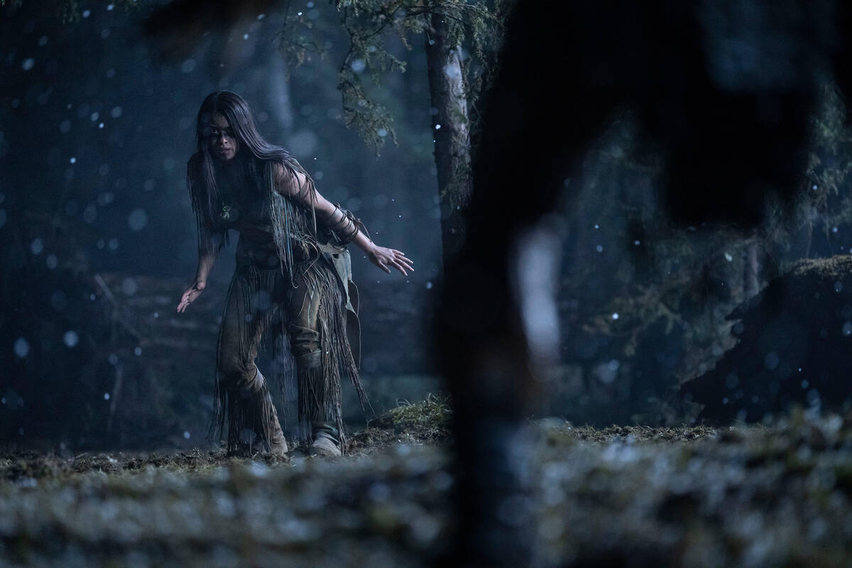 Naru (Amber Midthunder) and the Predator (Dane DiLiegro) in a scene from "Prey". (Pho ...