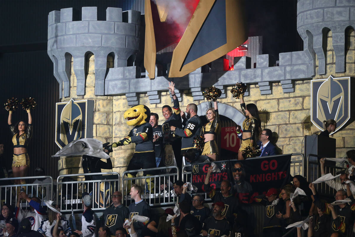 Wayne Newton raises his hand during the pregame show for Game 4 of the Western Conference Final ...