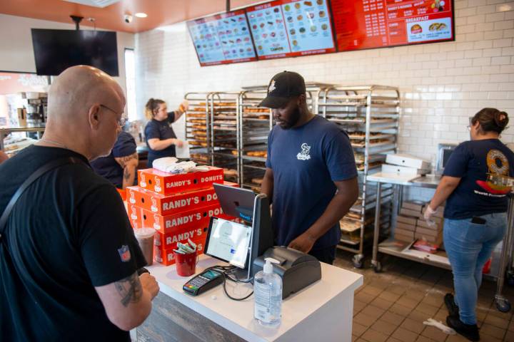 Daniel Ramadji serves customers at Randy's Donuts on South Rainbow Boulevard on Friday, Aug. 19 ...