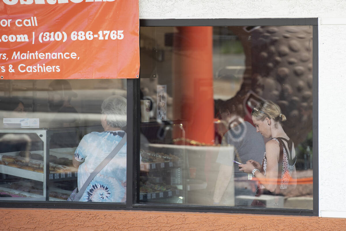 Customers wait in line at Randy's Donuts on South Rainbow Boulevard on Friday, Aug. 19, 2022, i ...