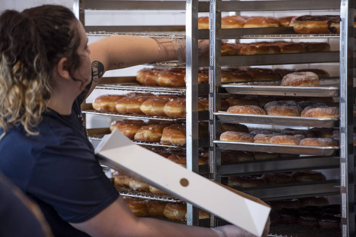Ren Martin packs a box for a customer at Randy's Donuts on South Rainbow Boulevard on Friday, A ...