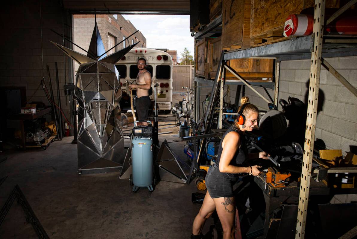 Brad Allen, left, and Mary Fuson, metalworker, work on The Metaphoenix art car, in preparation ...