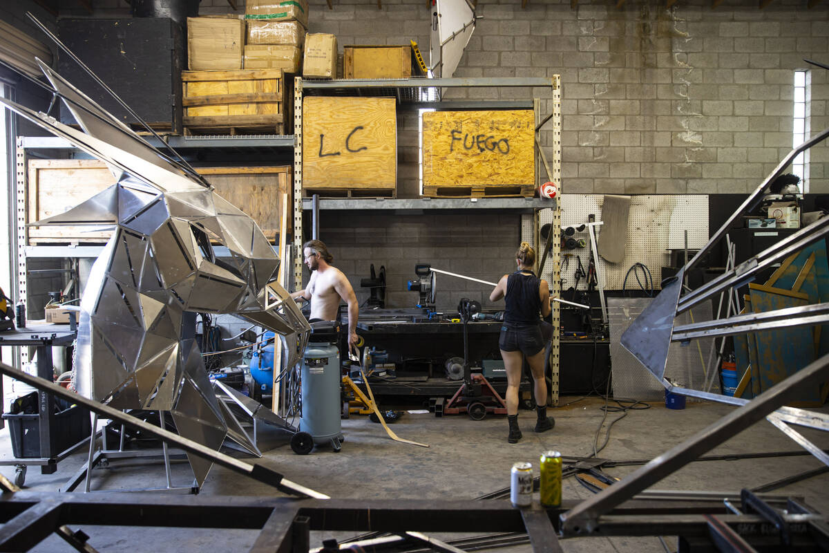 Brad Allen, left, and Mary Fuson, metalworker, work on The Metaphoenix art car, in preparation ...