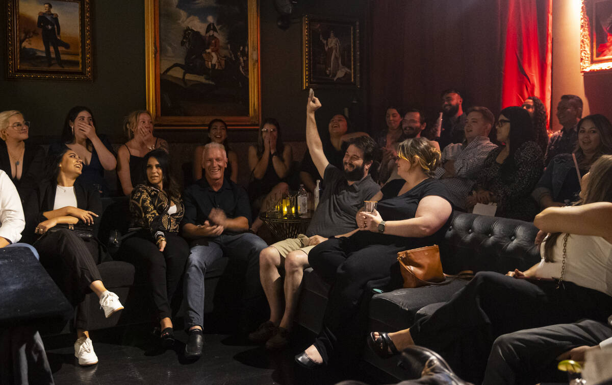 Evan Fribourg, of San Francisco, holds up a card as The Magician, not pictured, of The Magician ...