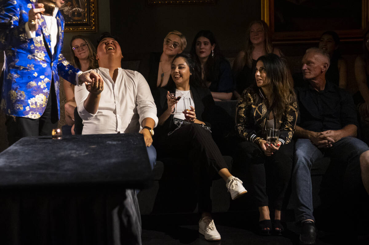 The Magician, of The Magician's Study, interacts with audience member Carlos Rivera, of El Paso ...