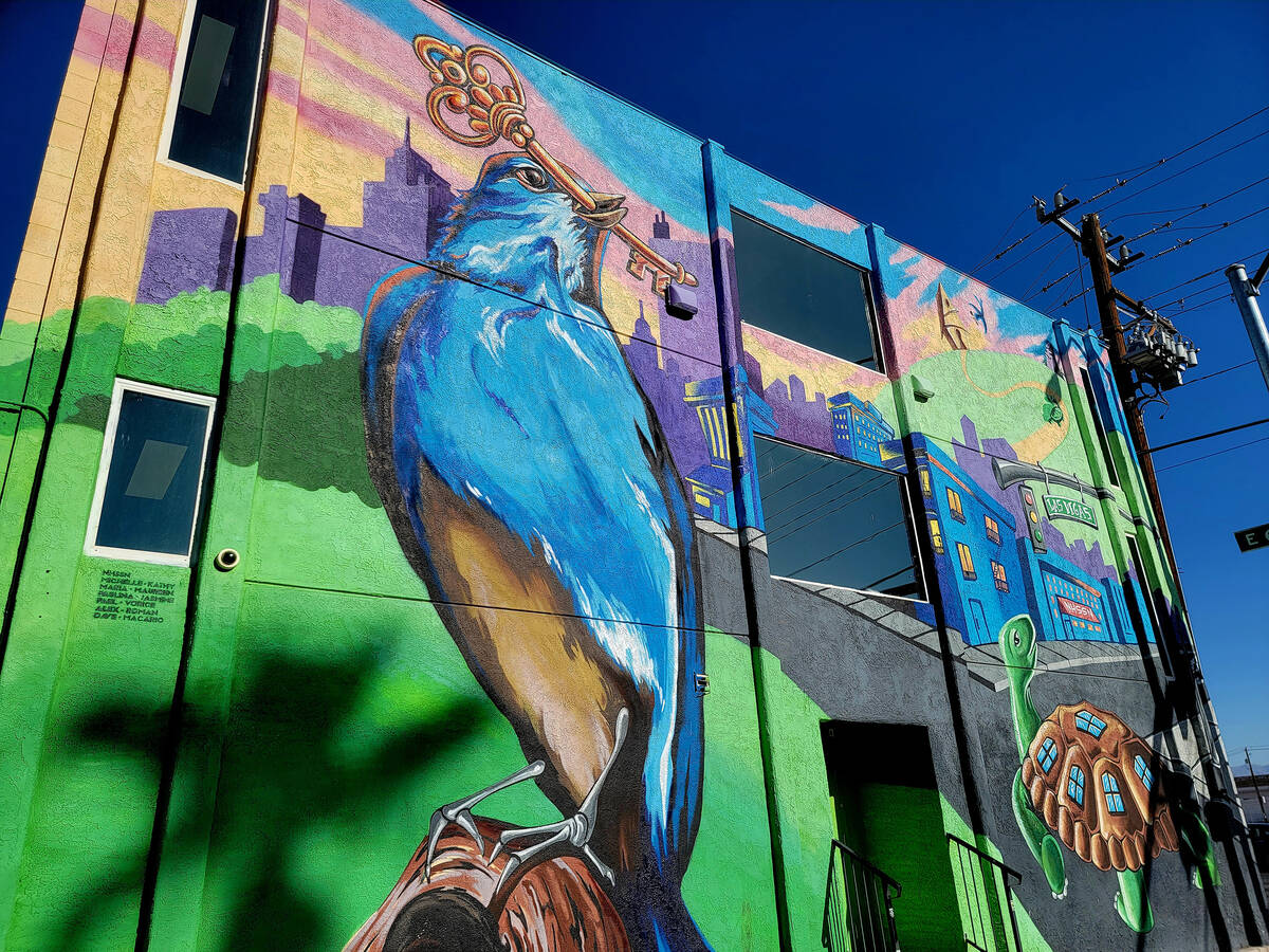 This mural with a bird holding a key in its beak and a turtle wearing windows on its back is fo ...