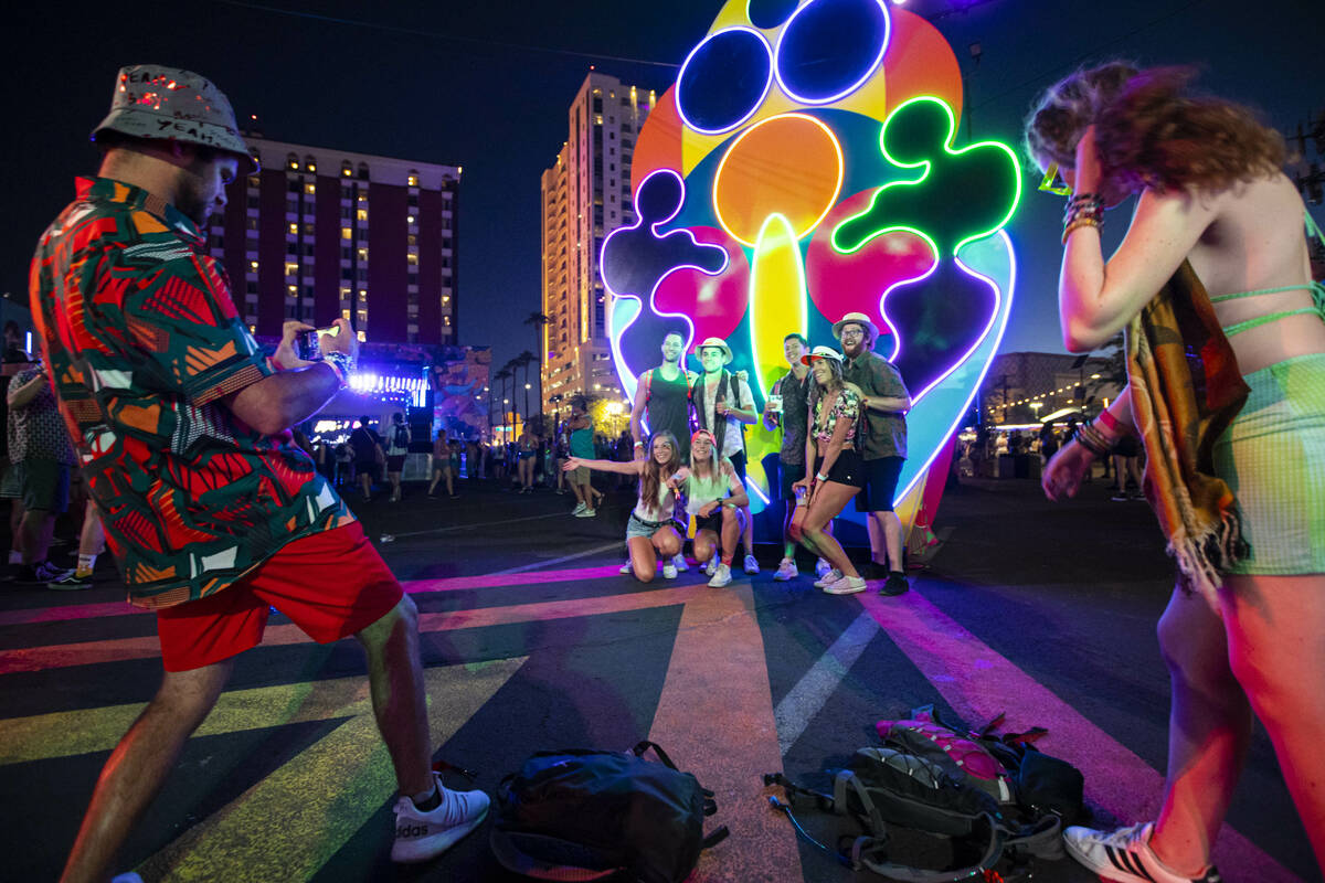 Attendees pose for pictures during the first day of the Life is Beautiful festival on Friday, S ...