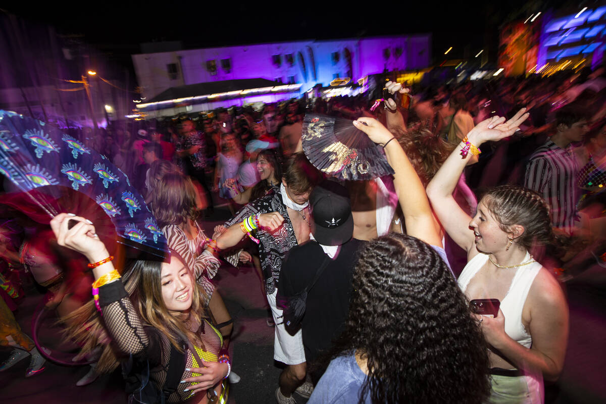Attendees dance as Charli XCX, not pictured, performs during the first day of the Life is Beaut ...