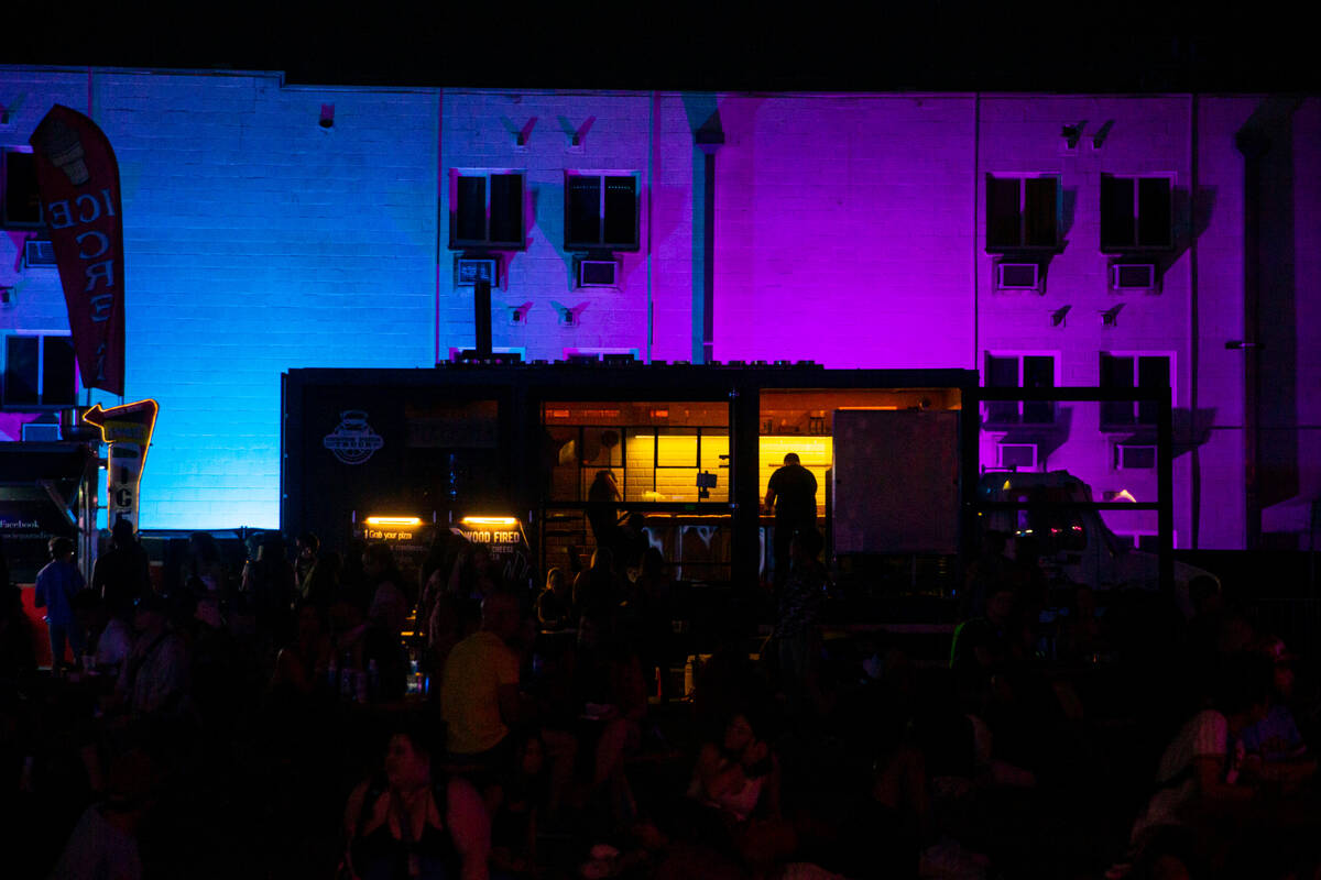 A worker is silhouetted in a food truck during the first day of the Life is Beautiful festival ...