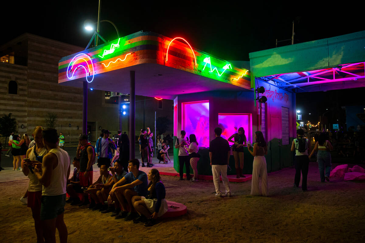 Attendees take a break by the former 1931 gas station at Fremont and 8th Streets during the fir ...