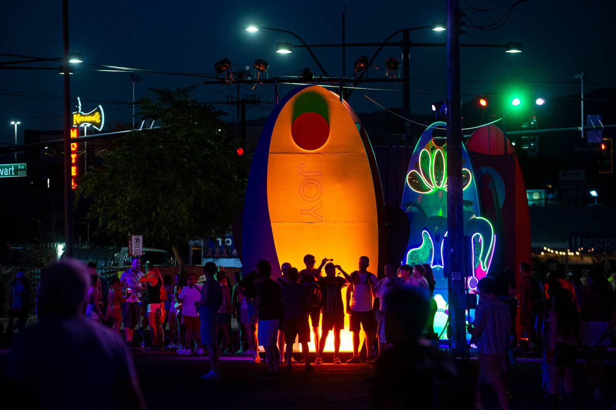 Attendees are silhouetted by an art installation during the Life is Beautiful festival on Sunda ...