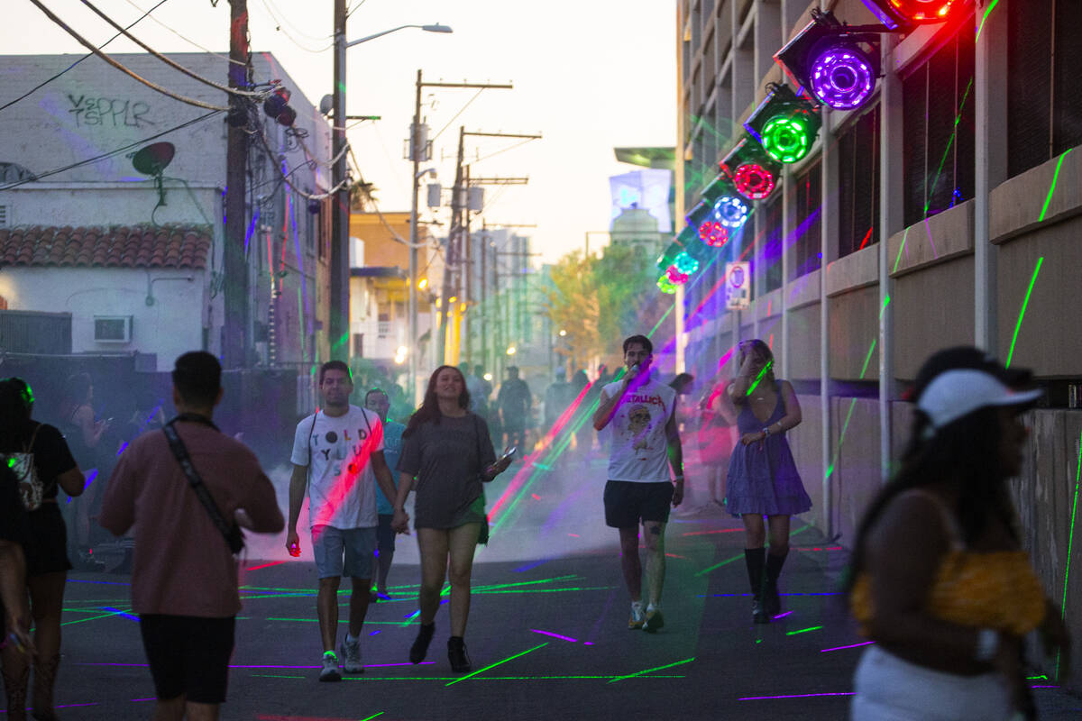 Attendees walk through a display of lights during the Life is Beautiful festival on Sunday, Sep ...