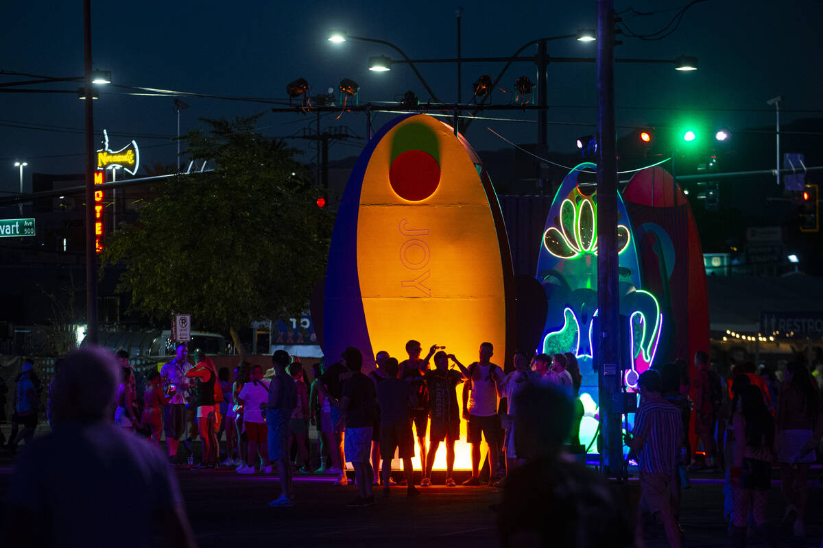 Attendees are silhouetted by an art installation during the Life is Beautiful festival on Sunda ...