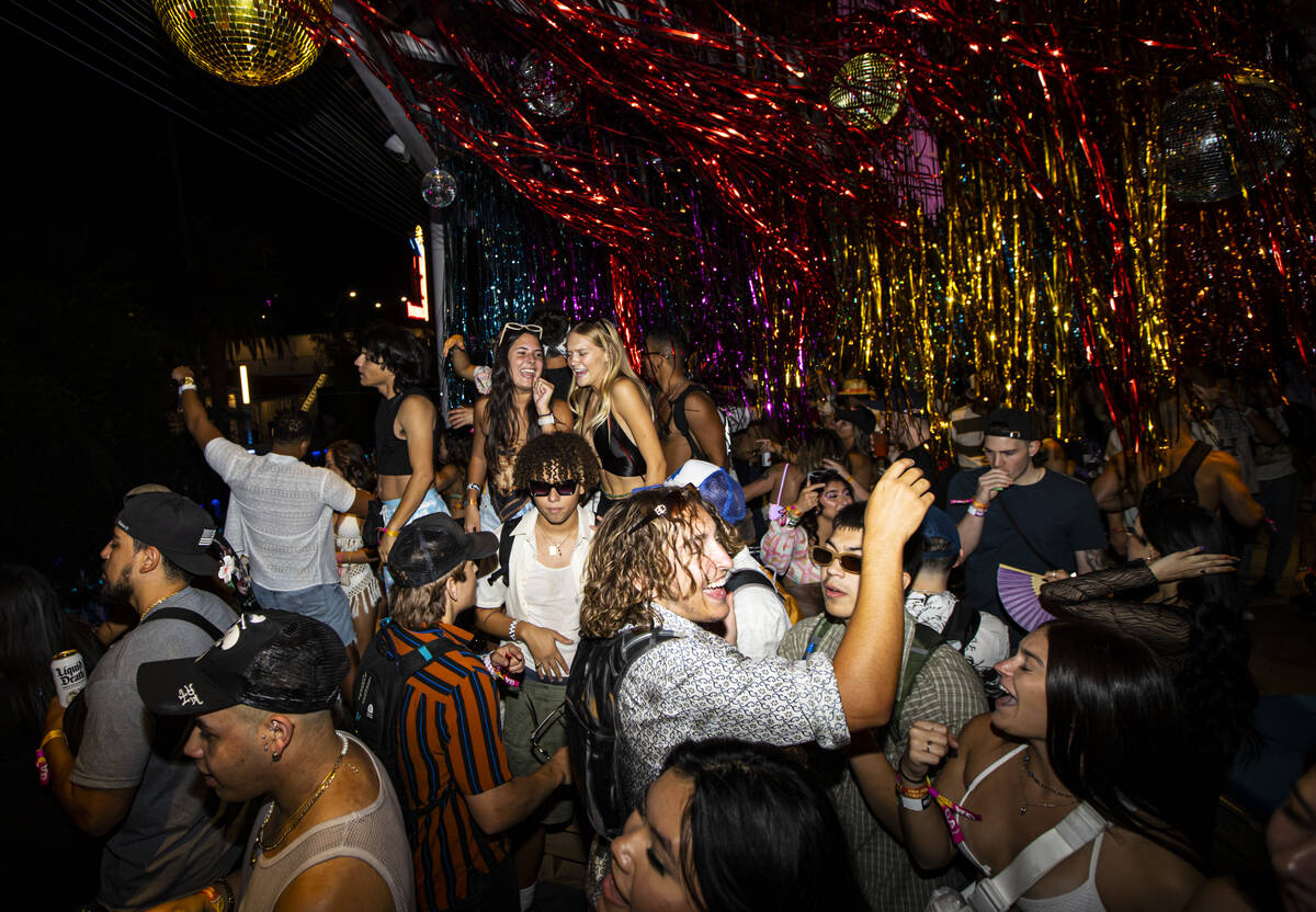 Attendees dance as DJ Angie Vee performs during the Life is Beautiful festival on Sunday, Sept. ...