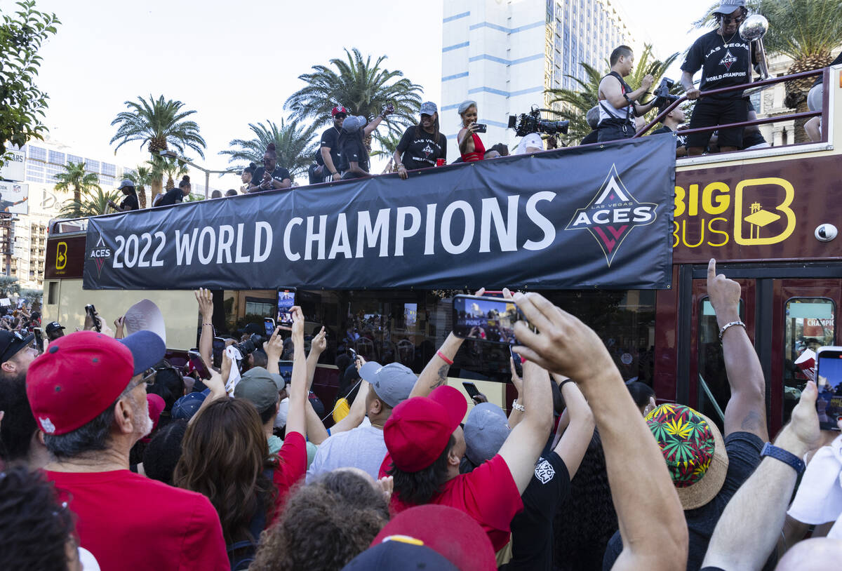 Fans watch as the Las Vegas Aces pass by during the team's WNBA Championship victory parade on ...