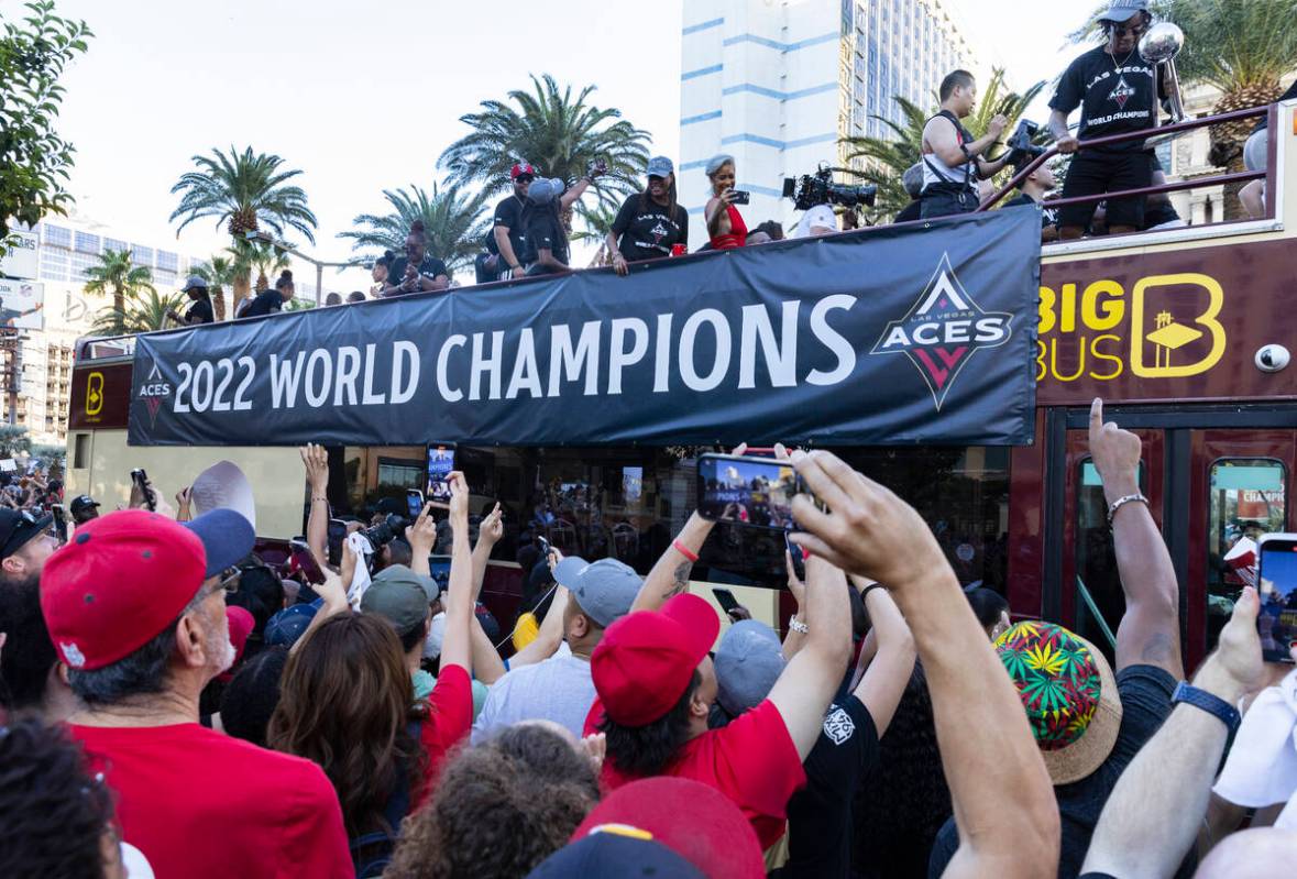 Fans watch as the Las Vegas Aces pass by during the team's WNBA Championship victory parade on ...
